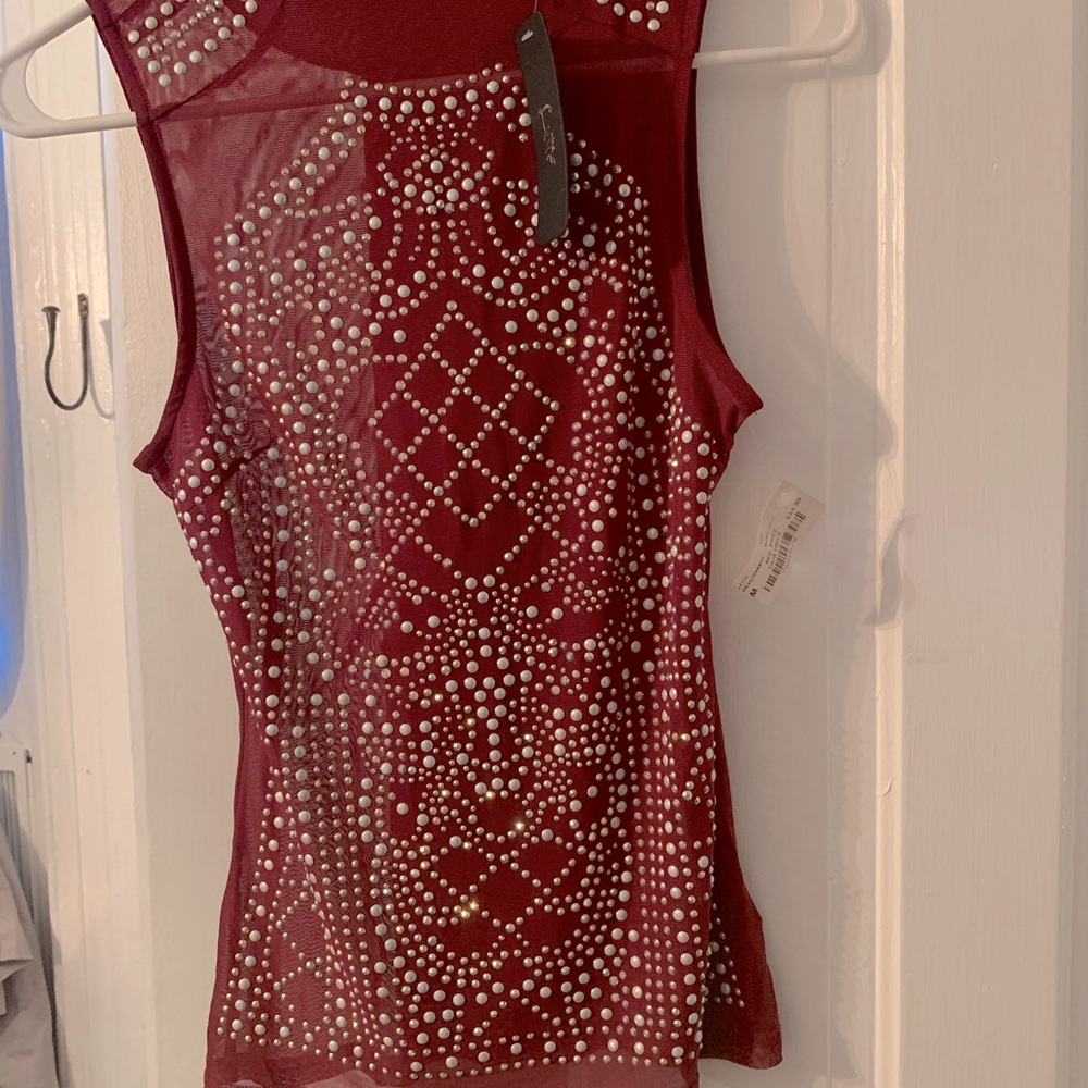 burgundy top, bejeweled front, shirt is small.